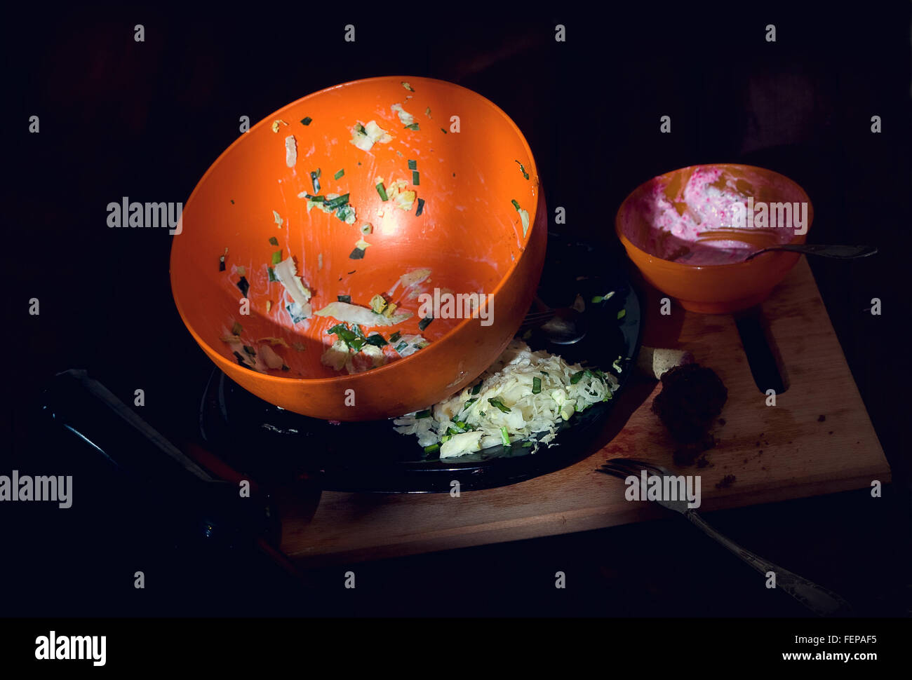 pile unharvested and washed dirty dishes and garbage in the morning on the dining table Stock Photo