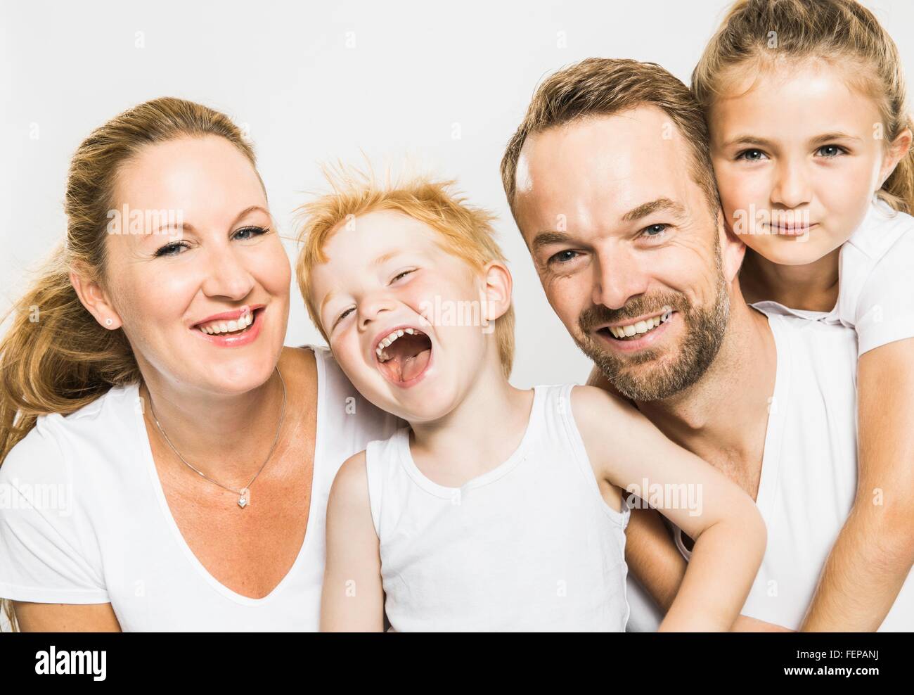 Studio portrait of happy boy and girl with mature parents Stock Photo