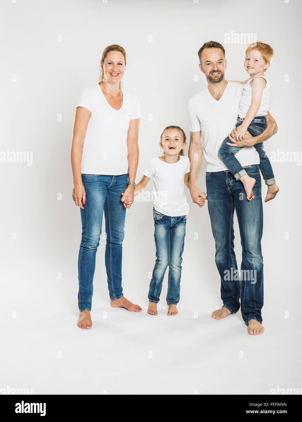 Studio portrait of mature parents with son and daughter Stock Photo