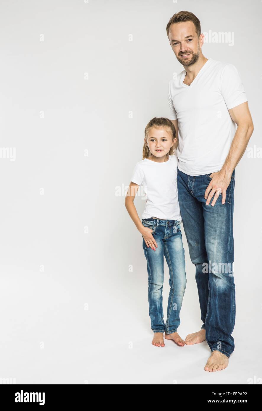 Studio portrait of girl and mature father Stock Photo