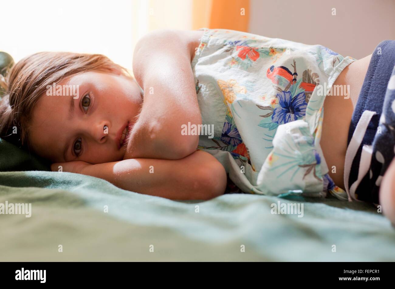 Girl lying down looking at camera Stock Photo