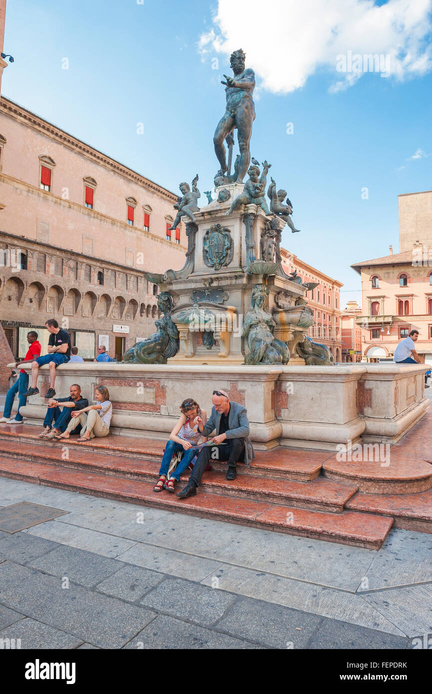 Bologna Neptune Fountain, view of tourists relaxing at the base of the