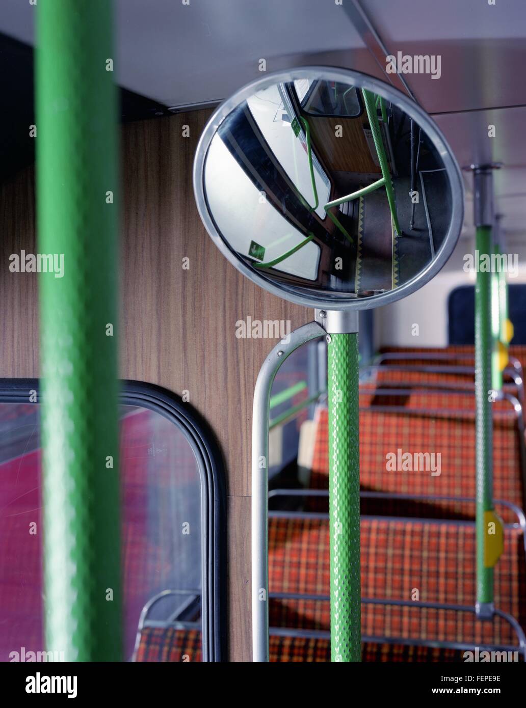 Convex mirror and seats upstairs in vintage double decker bus Stock