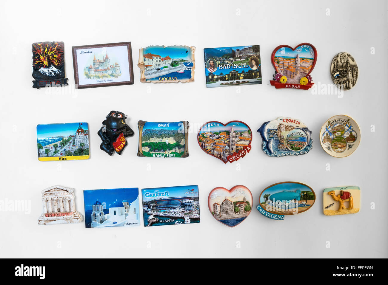 Fridge magnet souvenirs on the fridge from different locations (travel concept, traveling symbol) Stock Photo