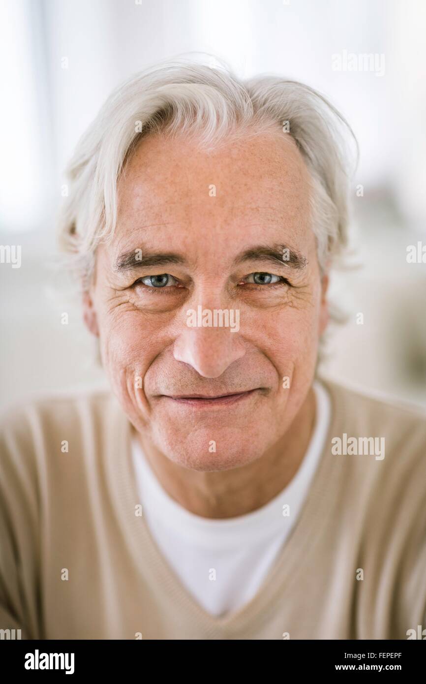 Portrait of grey haired senior man looking at camera smiling Stock Photo