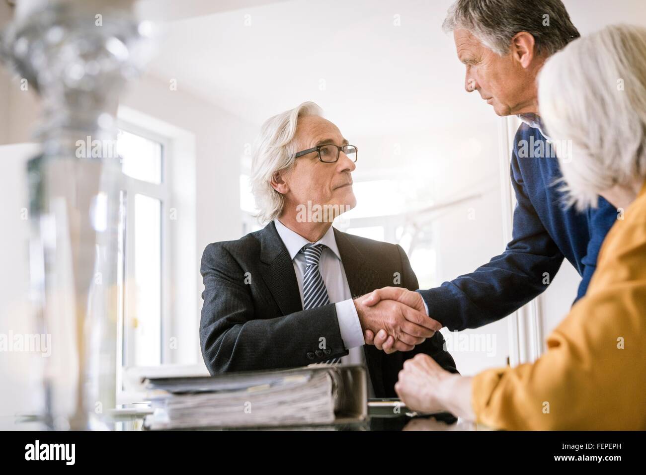 Senior adults in business meeting shaking hands Stock Photo