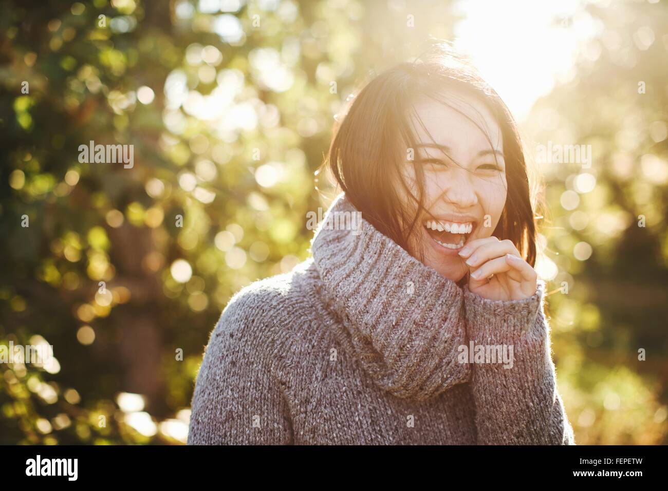 Portrait of young woman in rural environment, laughing Stock Photo