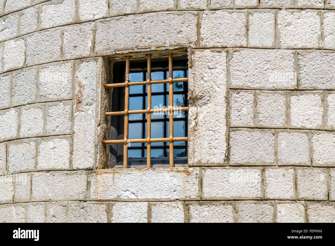Fortress wall window with iron rod Stock Photo