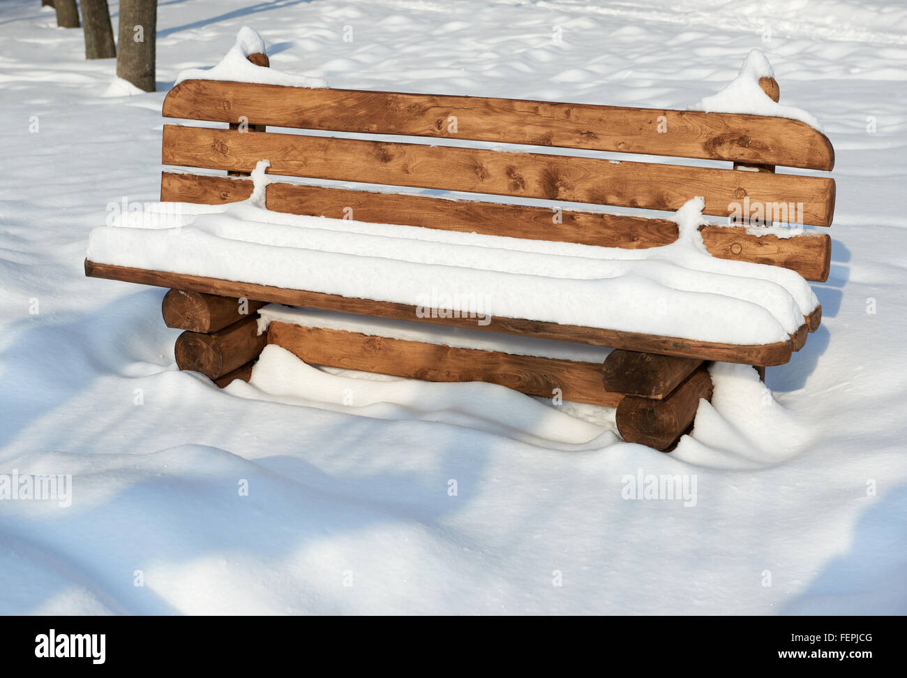 Wooden bench in the winter city park. Bright sunny day and snow Stock ...