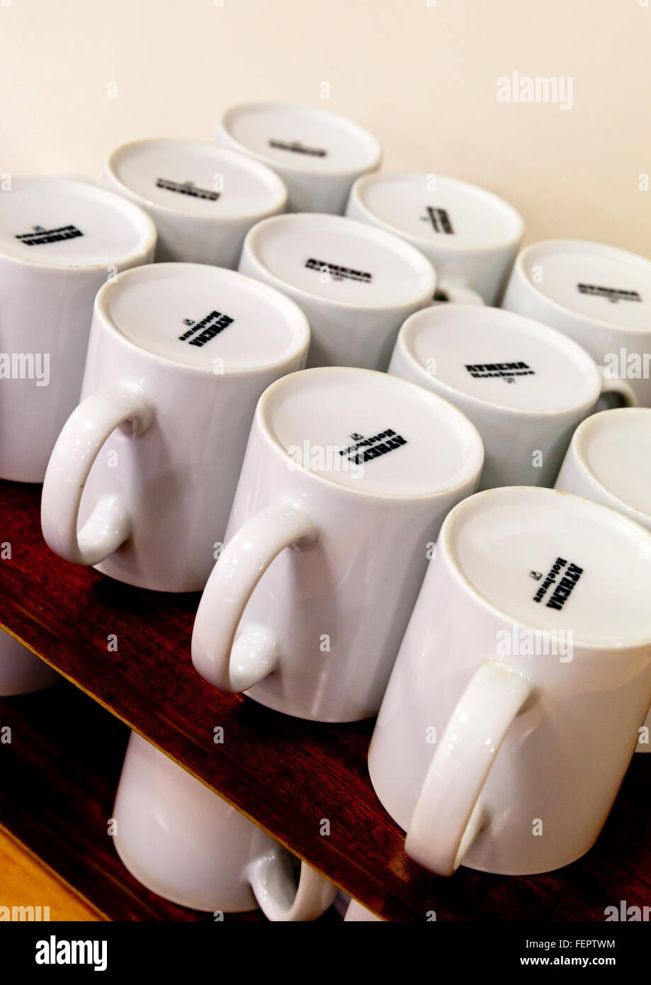 White china mugs on waiting to be used in a communal dining area Stock Photo