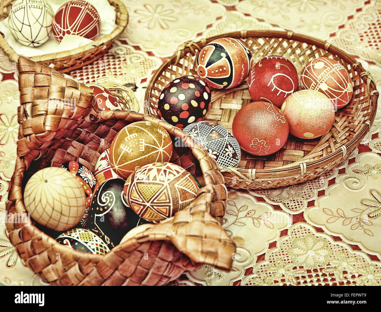 Multicolored easter eggs in straw pots on a table.Toned image Stock ...