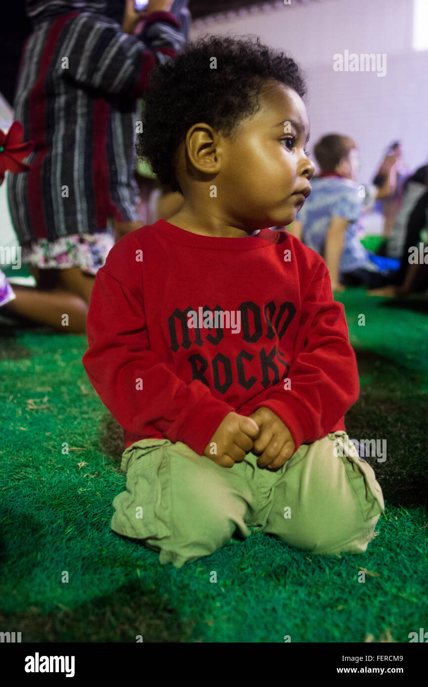 A little boy in red shirt at a park Stock Photo