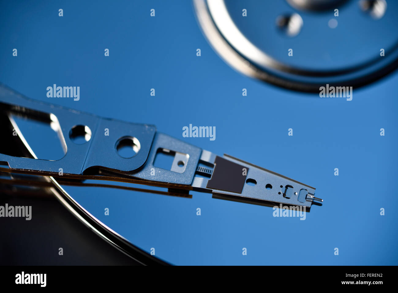 Close up of actuator arm on platter of hard disk drive data storage for laptop Stock Photo