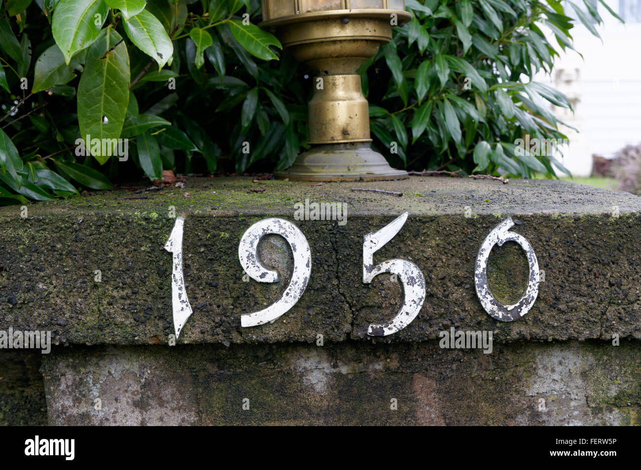1950 metal house number on concrete pillar Stock Photo