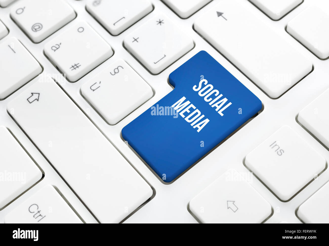 Social Media network business concept, blue enter button or key on white keyboard photography. Stock Photo