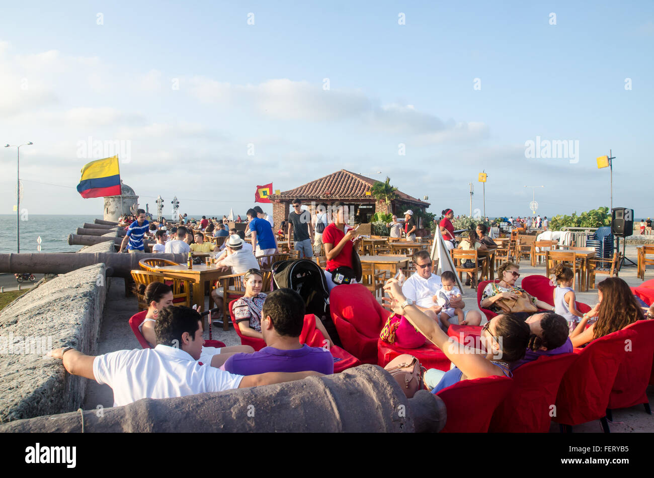 Crowds taking in the sunset at Cafe del Mar, on the colonial stone wall surrounding the old town area of Cartagena, Colombia Stock Photo