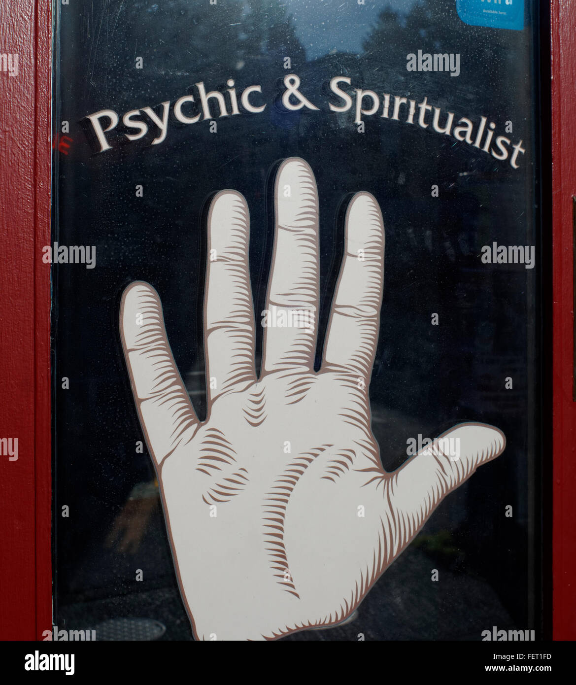 Hand on the door of a pyschic store in Vancouver, BC, Canada Stock Photo