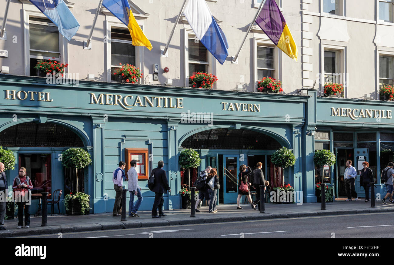 Front entrance to the Mercantile Tavern in Dame Street, Dublin, Republic of Ireland, with pedestrians on the pavement. Stock Photo