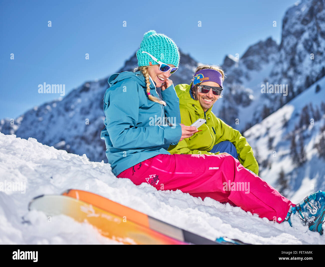 Skiers sitting in the snow taking a break, Mutterer Alm, Mutters, Tyrol, Austria Stock Photo