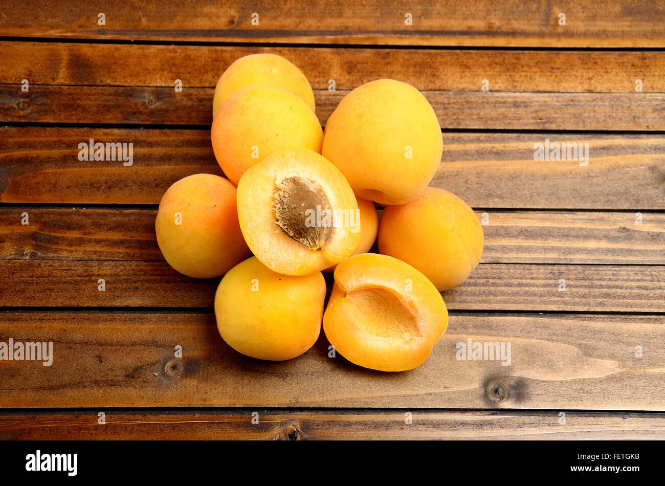 Heap of apricots fruit on wooden table Stock Photo