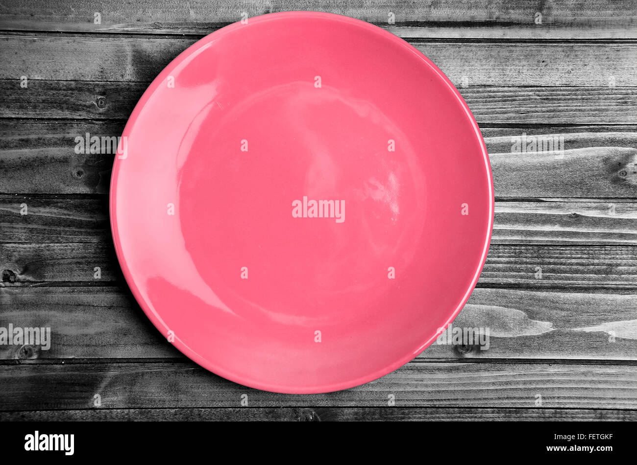 Empty pink plate on gray wooden table Stock Photo