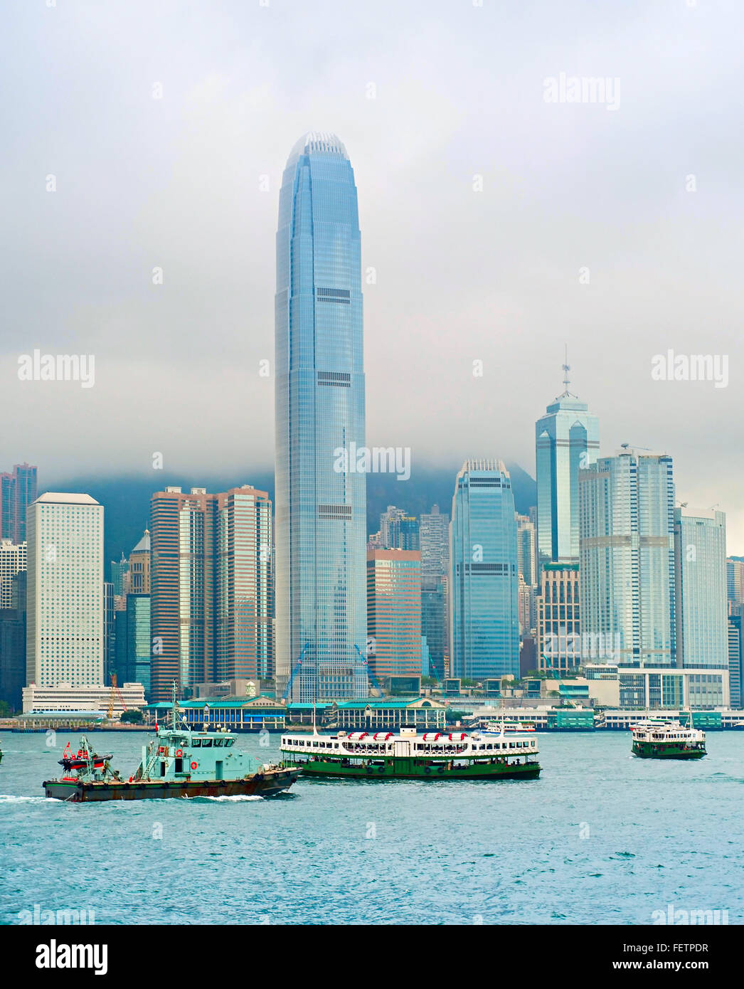 Hong Kong bay with many different ships and rainy clouds Stock Photo