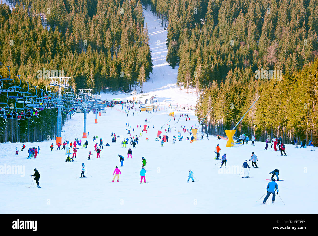 Crowded ski slope in the mountains at ski resort Stock Photo, Royalty ...