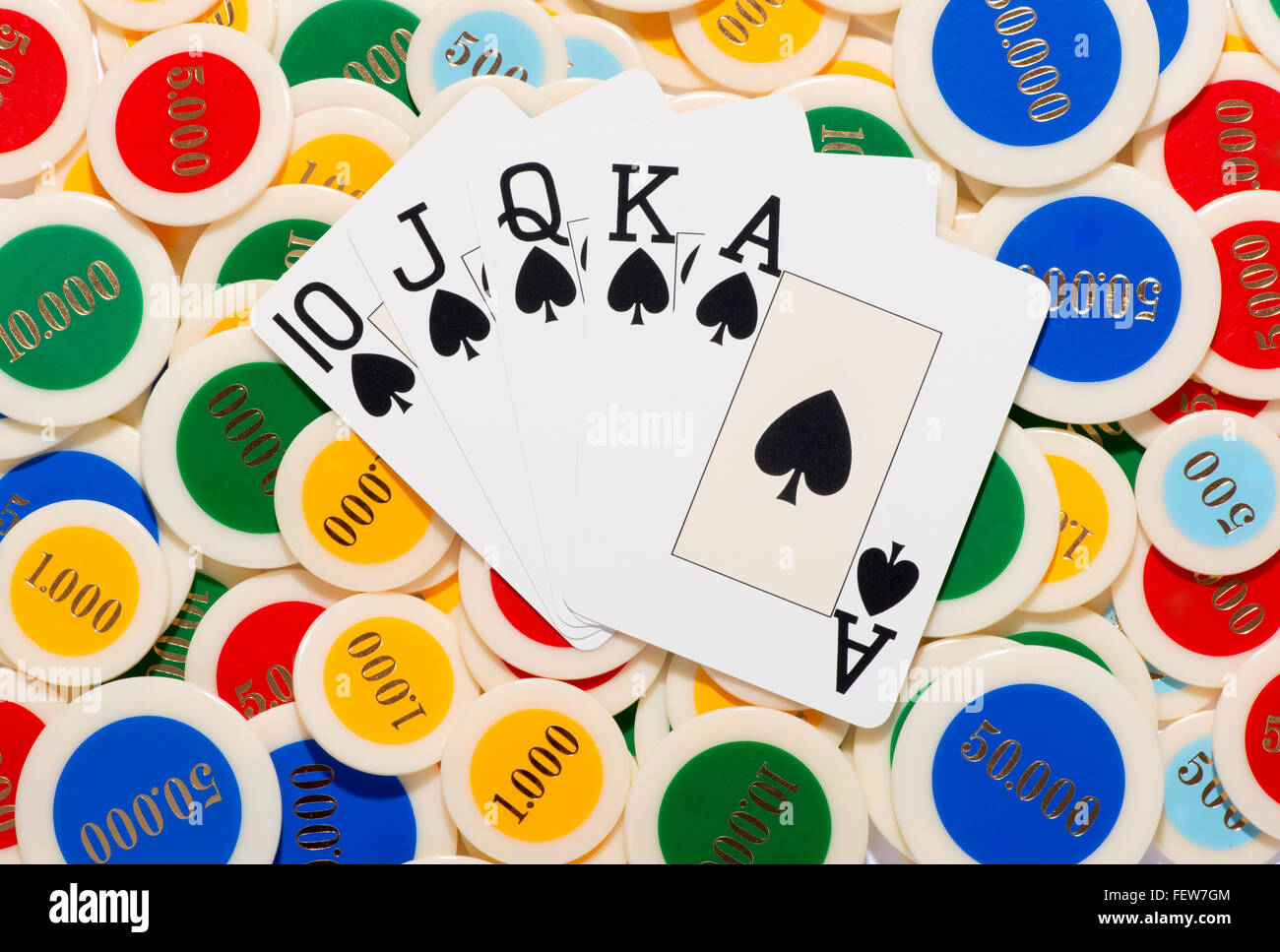 Poker hand with a straight flush in spades fanned over a colorful