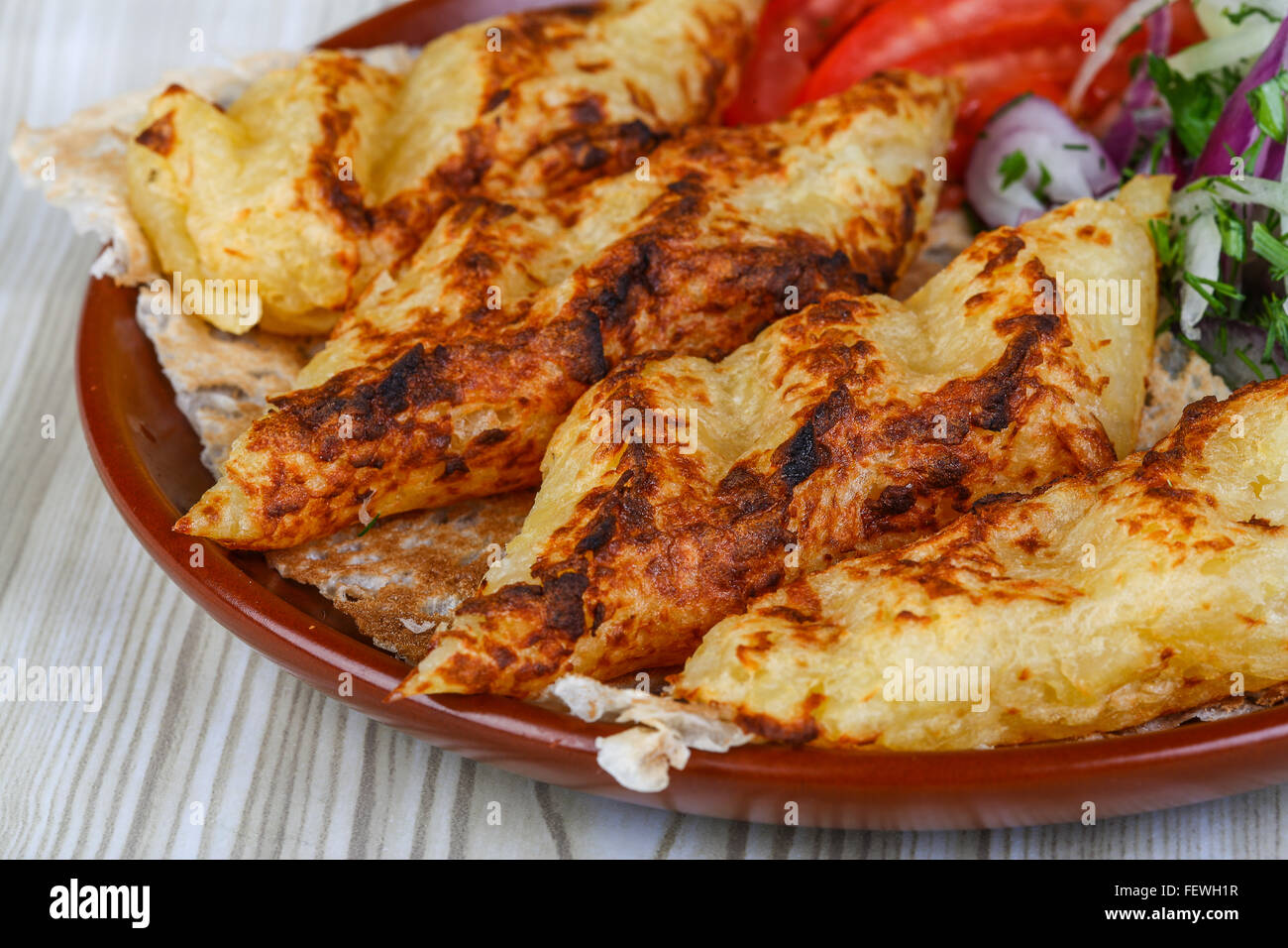 Grilled potato kebab served bread, tomato, salad and onion rings Stock