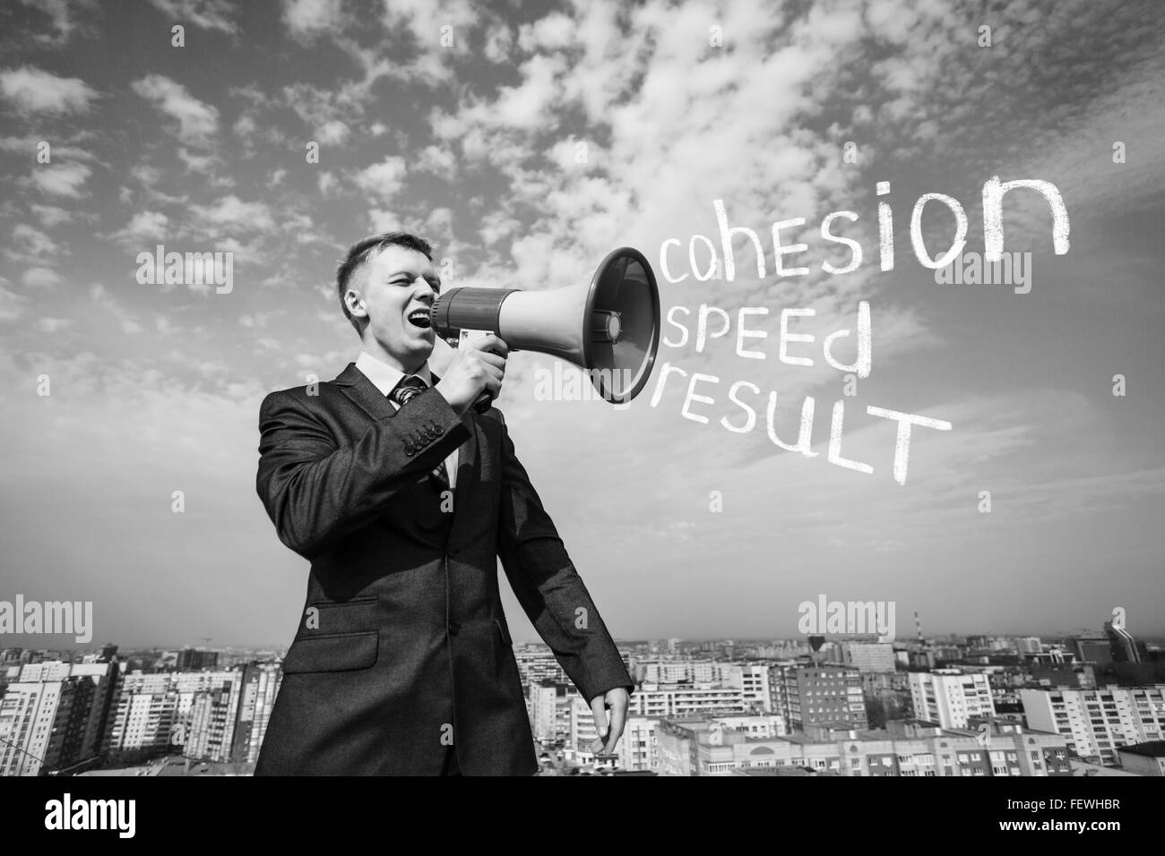 Businessman on the roof with megaphone Stock Photo