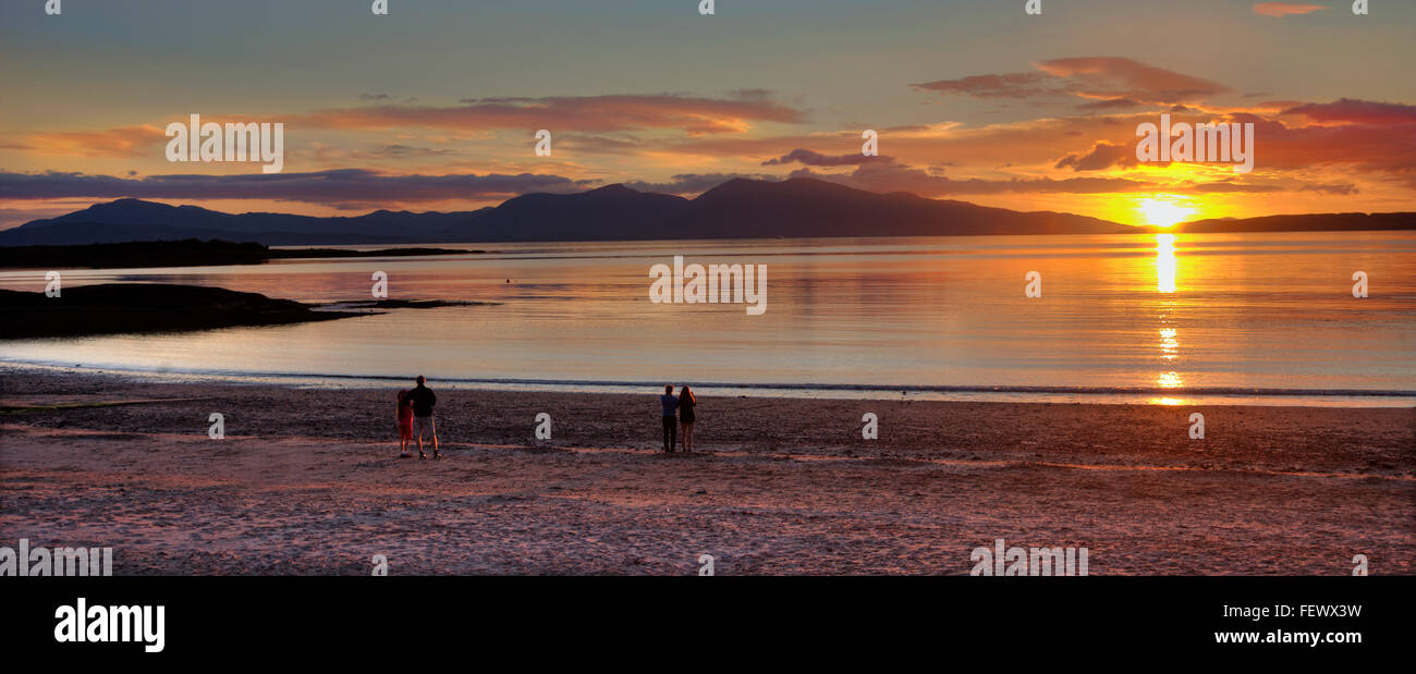 Sunset over Ganavan beach and a distant island of Mull, Argyll Stock Photo