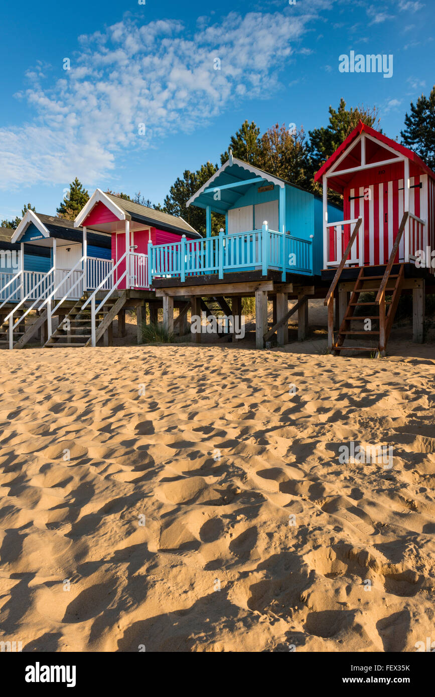 Colourful wooden beach huts on sandy beach of Wells next-the-Sea, Norfolk, UK Stock Photo