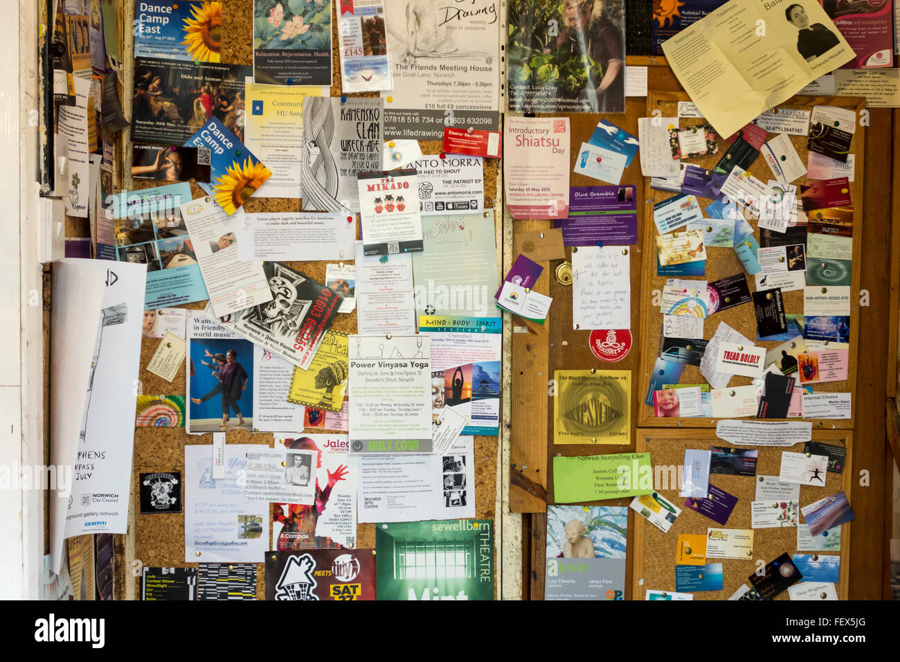 Chaotic display of business adverts on a noticeboard, UK Stock Photo