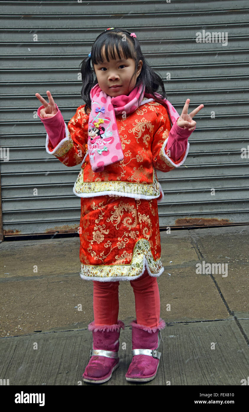 A beautiful 5 year old Chinese girl in a fancy dress at the Lunar New Year parade on Mott Street in Chinatown, New York City Stock Photo