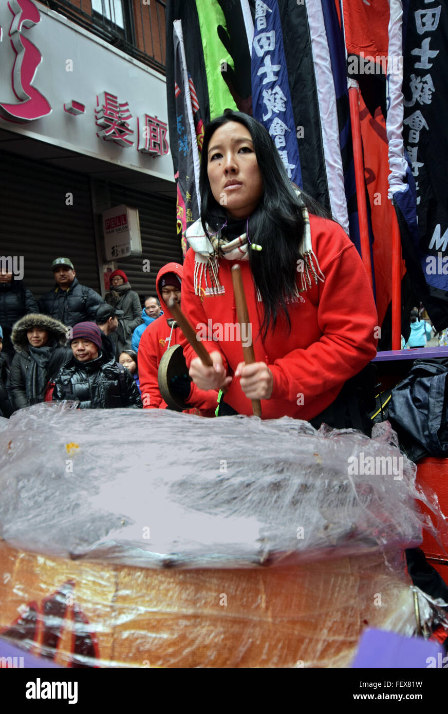 A pretty Chinese woman playing the drums in Chinatown New York on Lunar New Year's day, 2016 Stock Photo