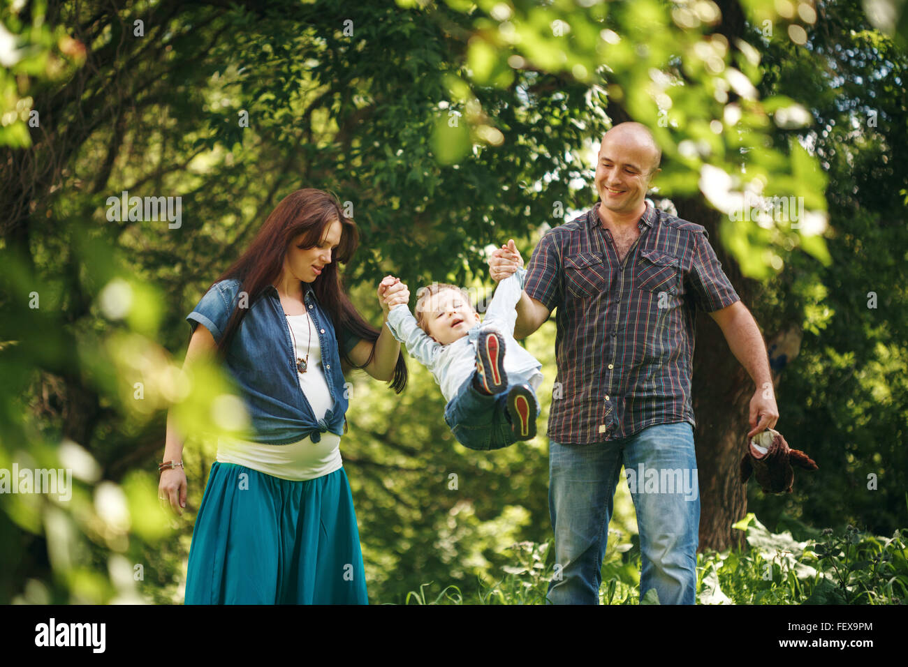 Happy Family Having Fun Outdoors. Young Parents Playing with Their Son ...