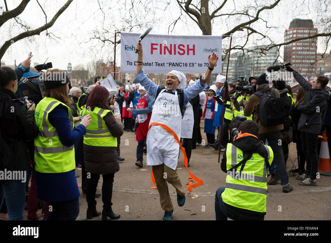 Westminster, London, UK. 9th February 2016. Clive Lewis and the MP'S team won the Rehab Parliamentary Pancake Race 2016 as runners representing the House of Commons, the House of Lords and the Parliamentary Press Gallery raced against each other while tossing pancakes Credit:  Keith Larby/Alamy Live News Stock Photo