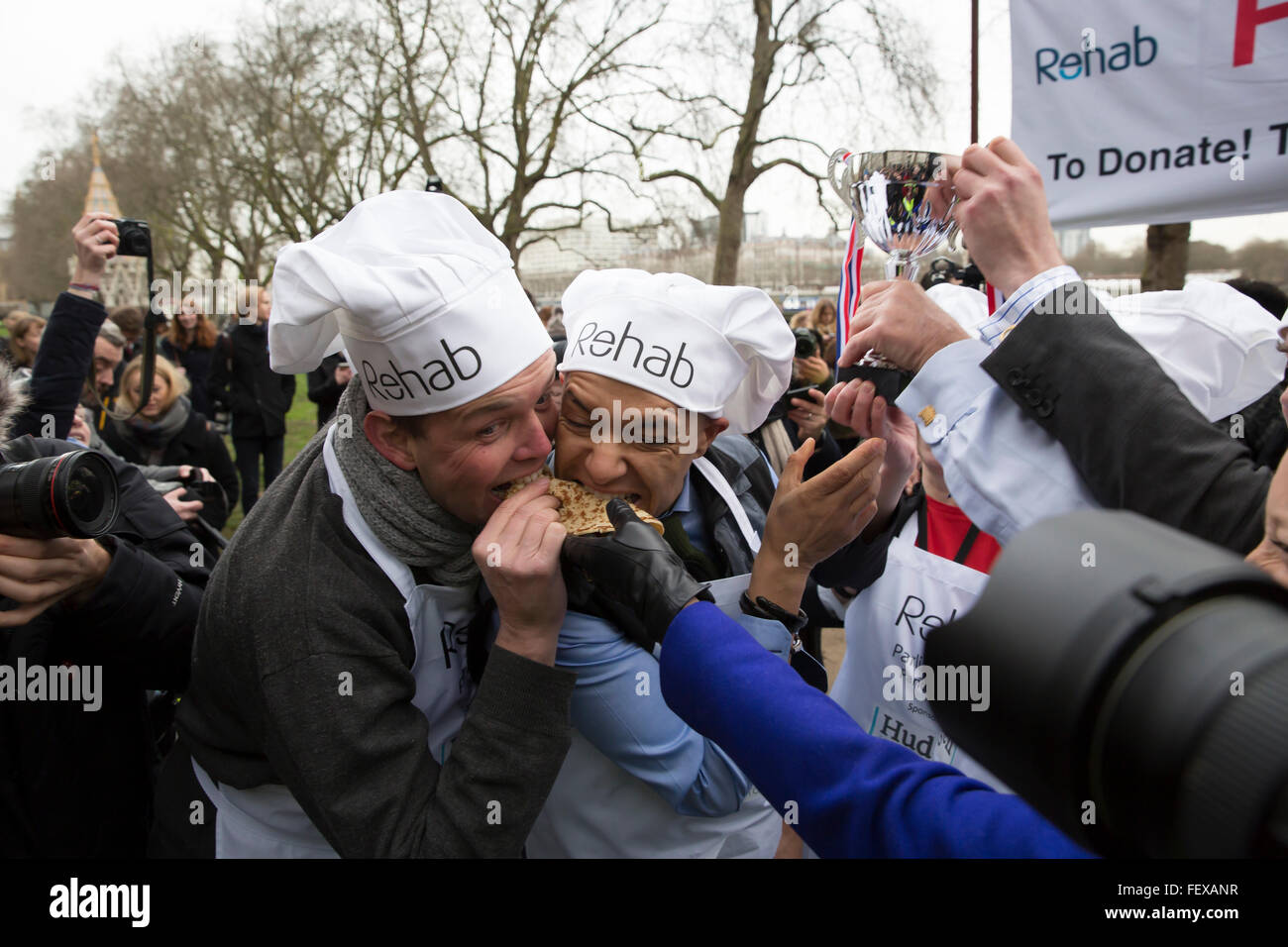 Westminster, London, UK. 9th February 2016. MP'S team celebrate by eating the pancakes after they won the Rehab Parliamentary Pancake Race 2016 as runners representing the House of Commons, the House of Lords and the Parliamentary Press Gallery raced against each other while tossing pancakes Credit:  Keith Larby/Alamy Live News Stock Photo