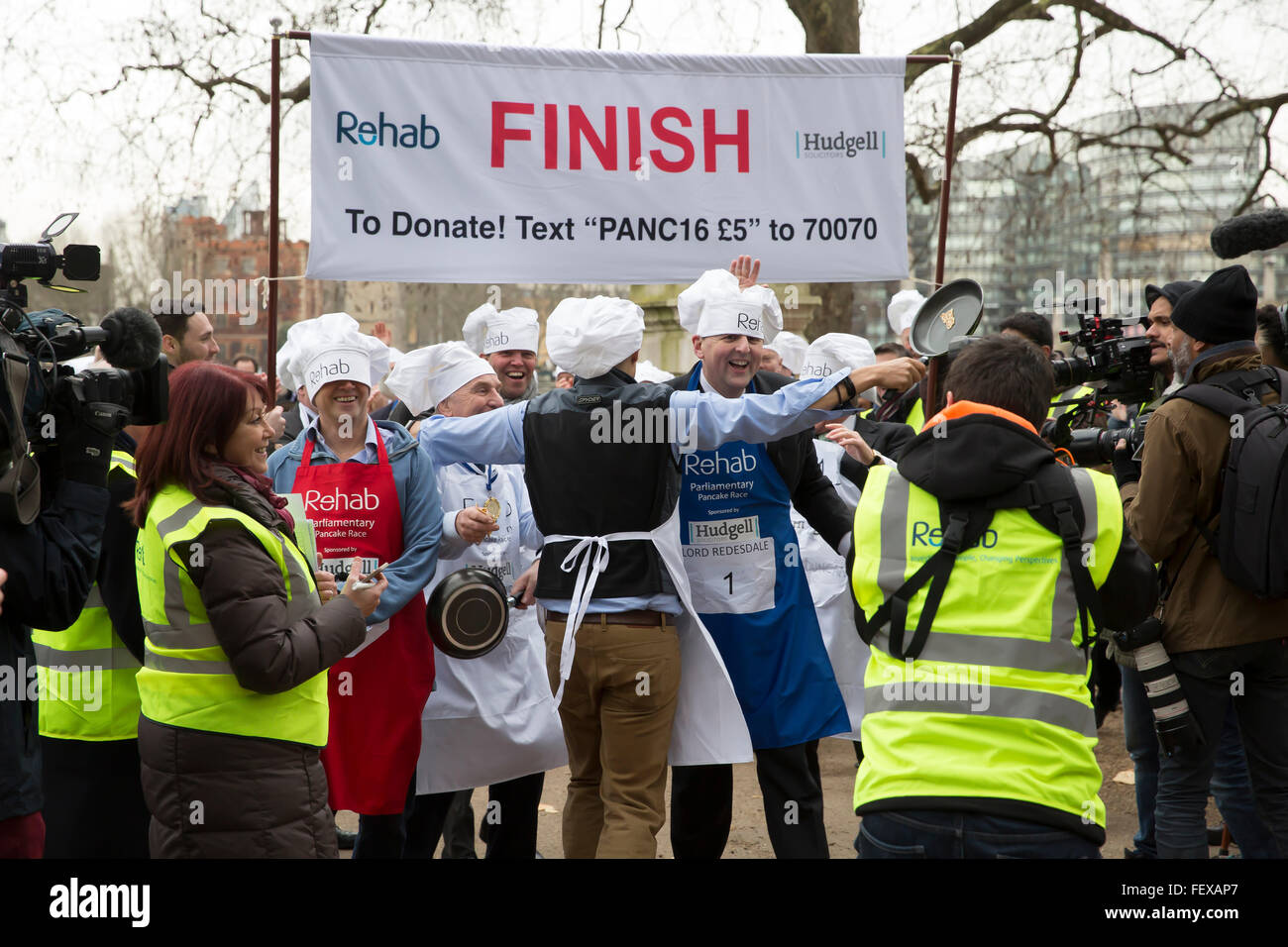 Westminster, London, UK. 9th February 2016. MP'S team celebrate after winning the Rehab Parliamentary Pancake Race 2016 as runners representing the House of Commons, the House of Lords and the Parliamentary Press Gallery raced against each other while tossing pancakes Credit:  Keith Larby/Alamy Live News Stock Photo