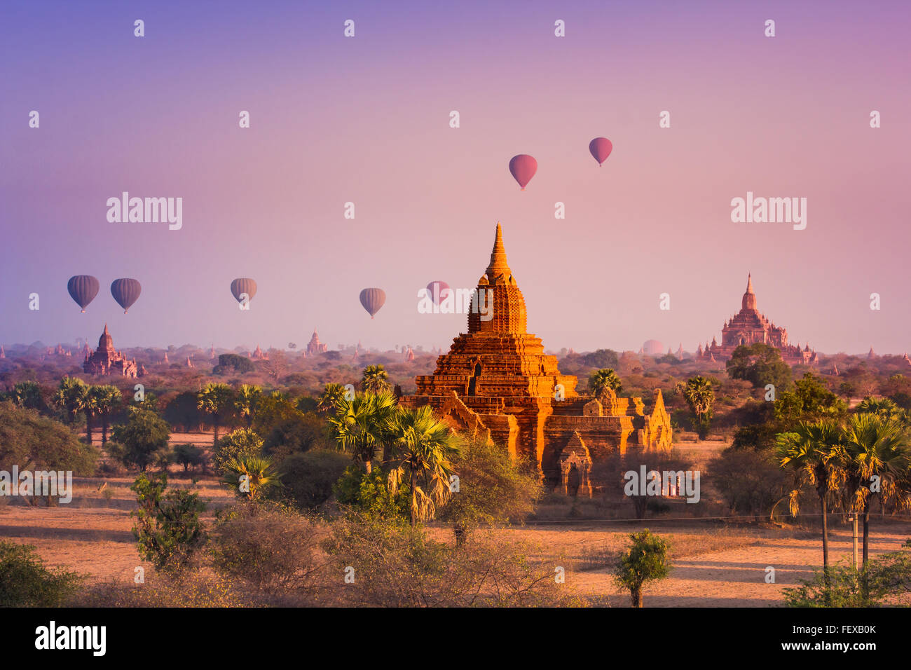 Hot air balloon over misty morning around Temple in Bagan , Myanmar Stock Photo