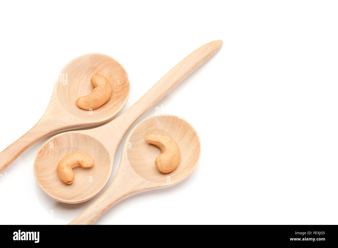 cashew nuts in spoon on wood arrange on white background Stock Photo