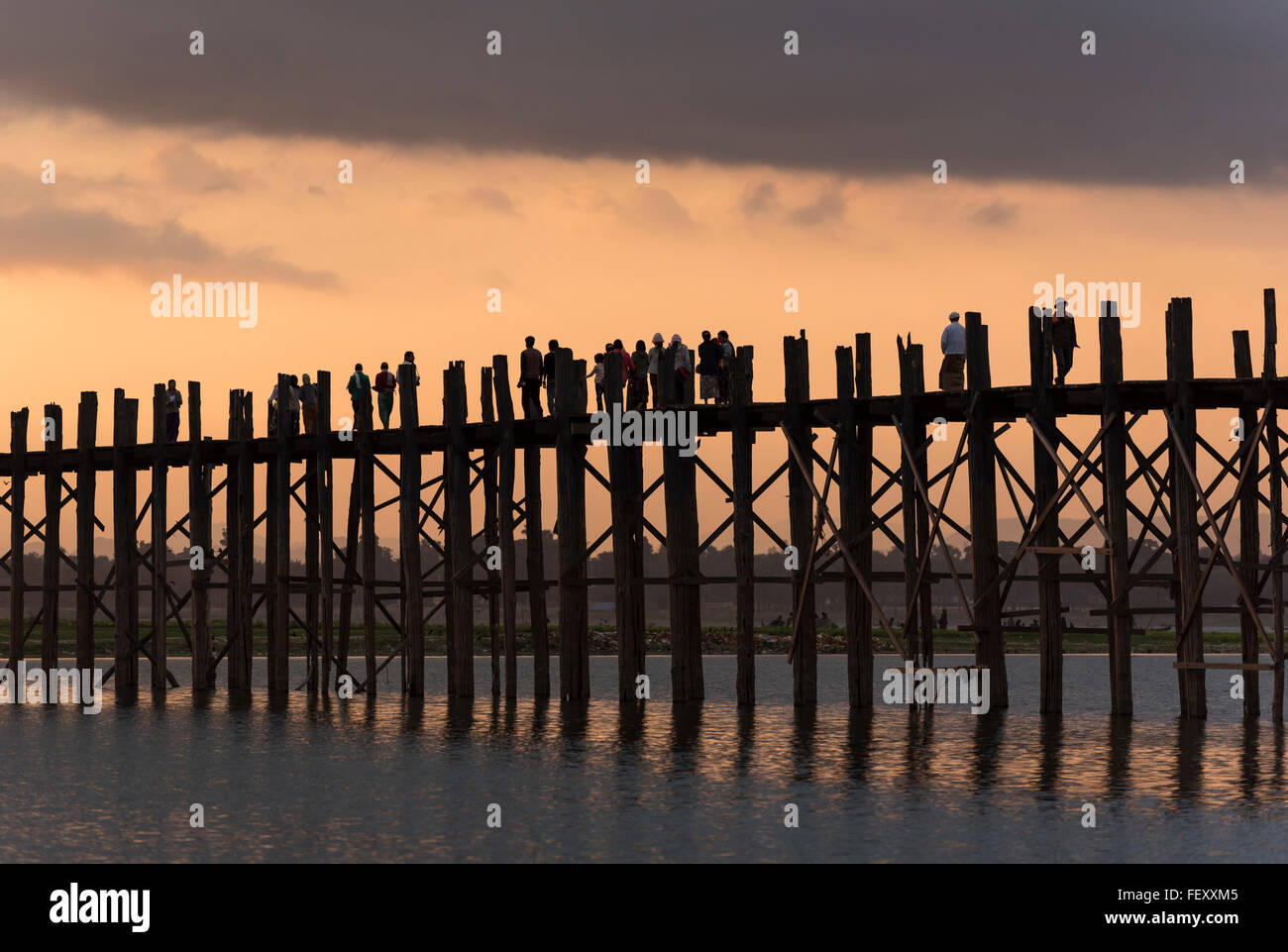 People walk the U Bein Bridge across the Taungthaman Lake in Amarapura ...