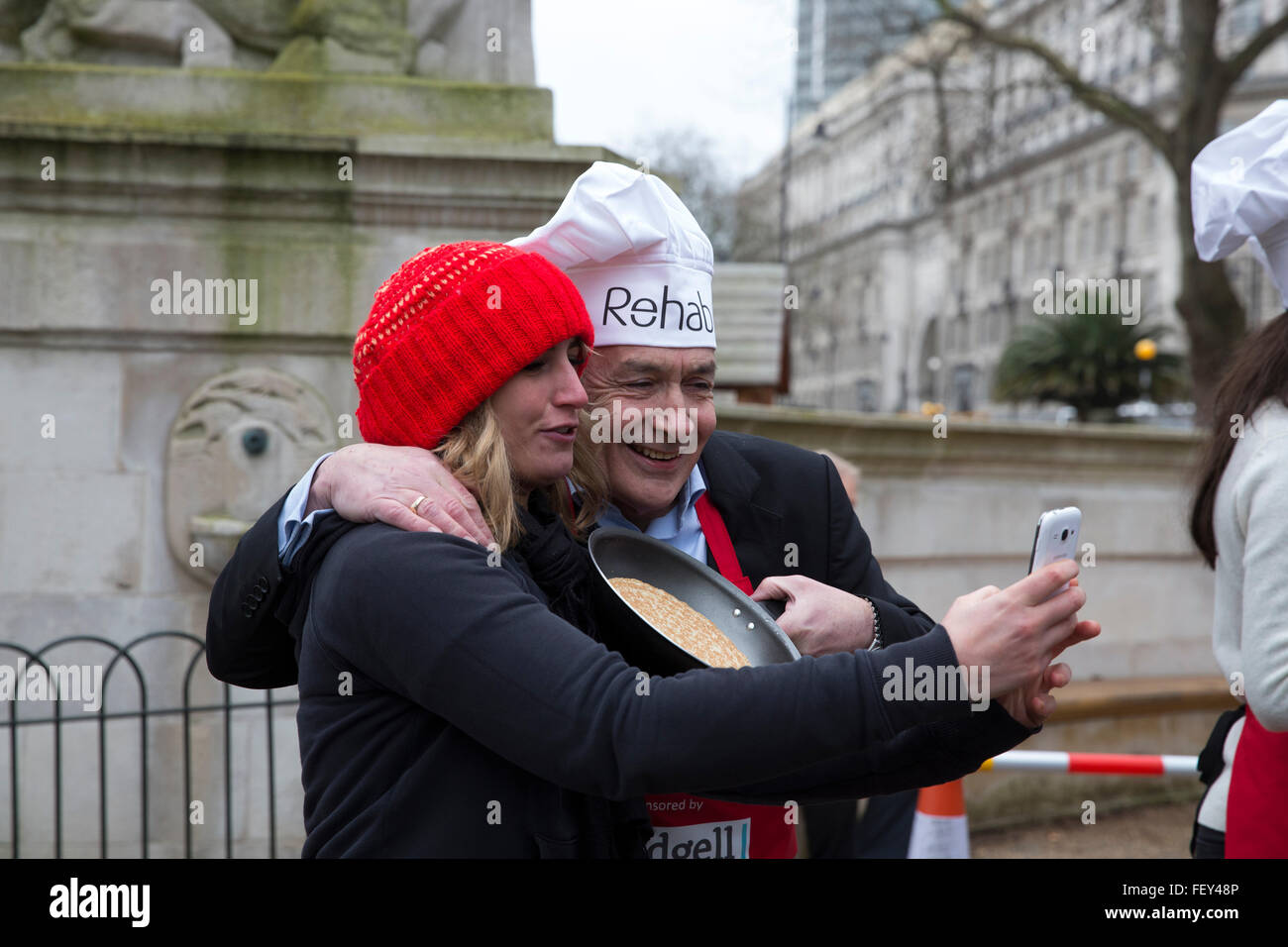 Westminster, London, UK. 9th February 2016. Alastair Stewart OBE, ITV news, poses for a selfie with Stephanie Frenny at the Rehab Parliamentary Pancake Race 2016 Credit:  Keith Larby/Alamy Live News Stock Photo