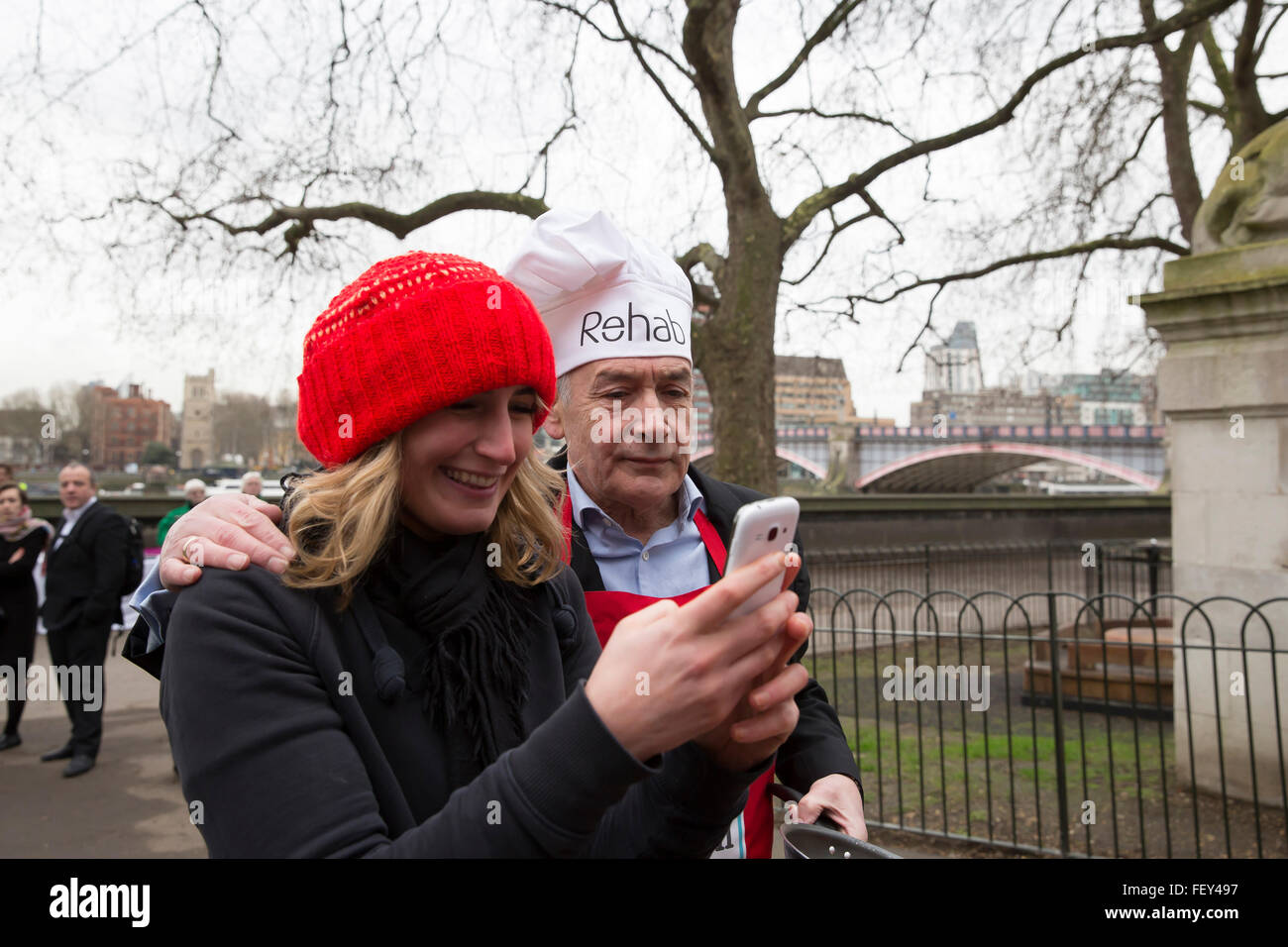 Westminster, London, UK. 9th February 2016. Alastair Stewart OBE, ITV news, poses for a selfie with Stephanie Frenny at the Rehab Parliamentary Pancake Race 2016 Credit:  Keith Larby/Alamy Live News Stock Photo