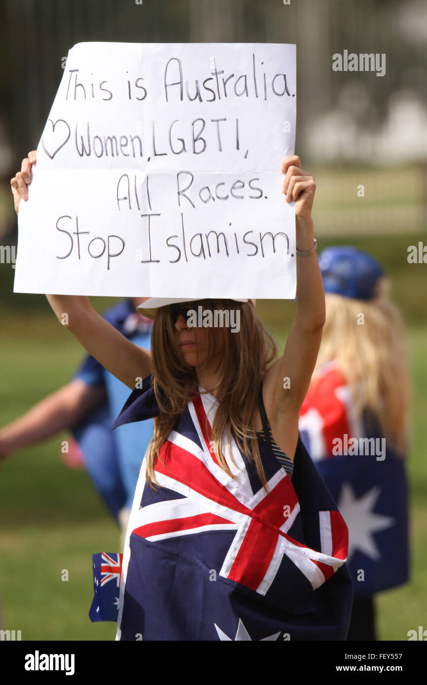 A protestor holds a sign saying, 'This is Australia. Women, LGBTI, All Races. Stop Islamism' at the PEGIDA rally in Canberra. Stock Photo