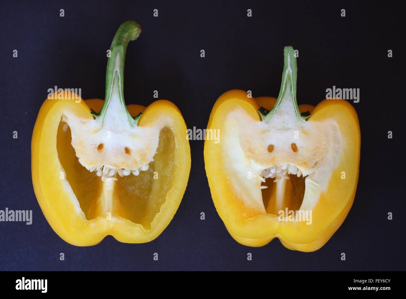 Close-Up Of Halved Yellow Pepper With Anthropomorphic Face Stock Photo