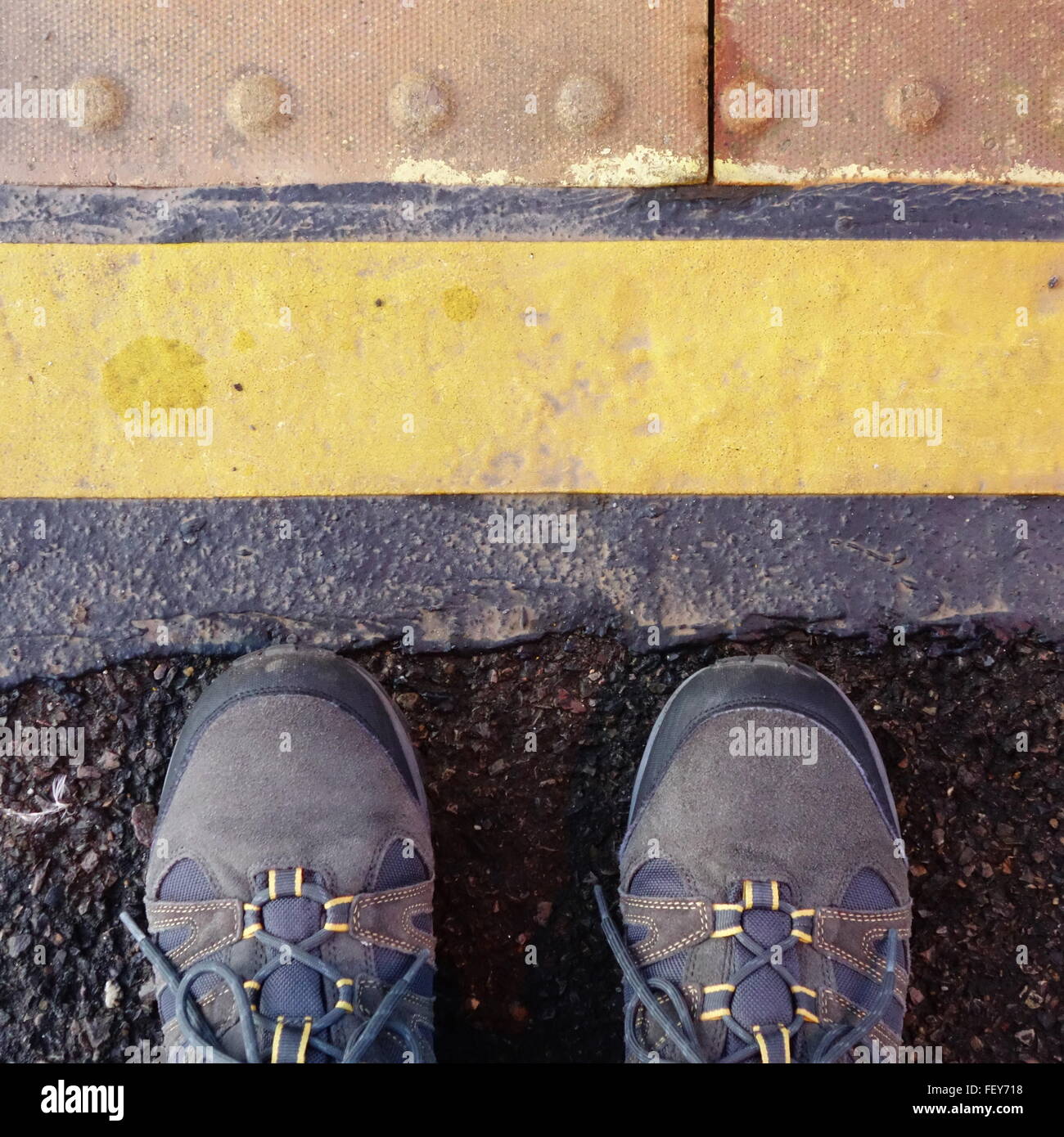 Stand behind the yellow line Stock Photo Alamy