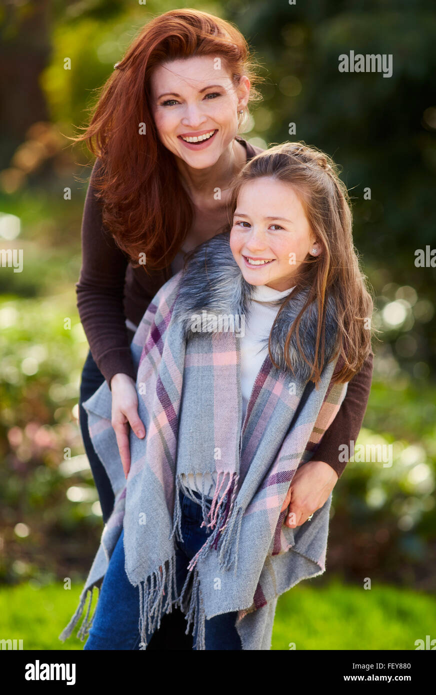 Mother and daughter stood together smiling Stock Photo