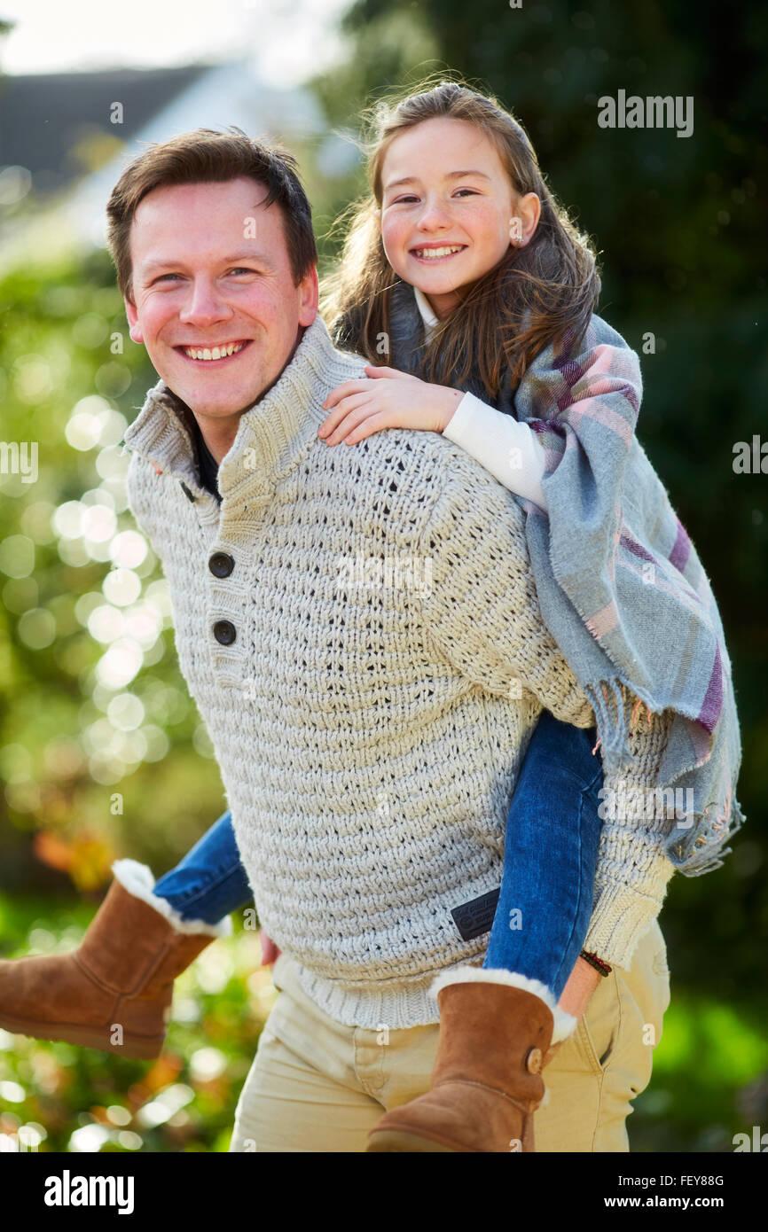 Father giving daughter piggyback Stock Photo