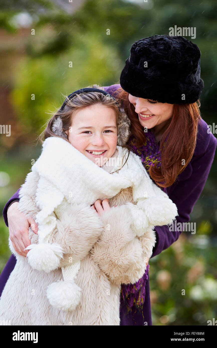 Mother and daughter stood together smiling Stock Photo